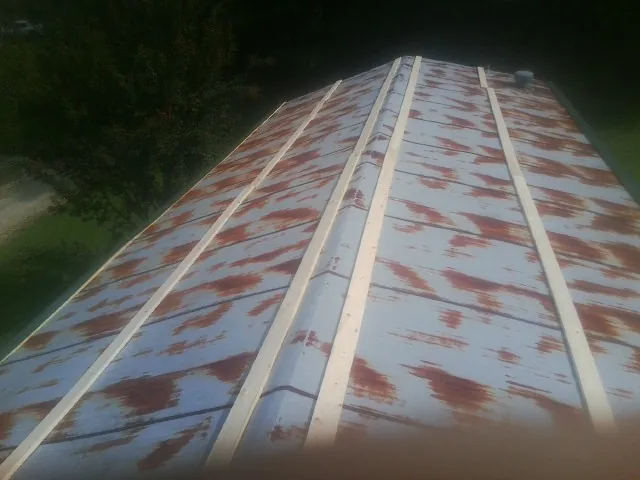 Rusted metal roof panels with new wood purlins before replacement — Storm Damage Roof Repair in Eagle Creek by Roofing Brothers