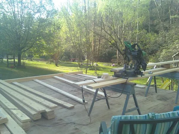 Miter saw and framing lumber on a deck under construction in Eagle Creek